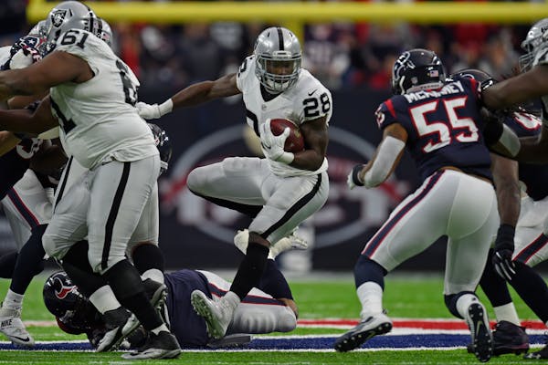 Oakland Raiders running back Latavius Murray (28) carries the ball against the Houston Texans in the second quarter of the AFC Wild Card Playoff at NR