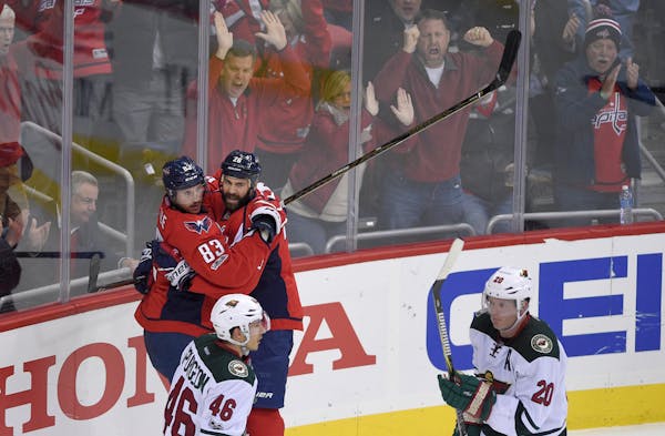 Capitals center Jay Beagle (83) celebrated his goal with left wing Daniel Winnik as Wild defensemen Jared Spurgeon (46) and Ryan Suter skated by durin