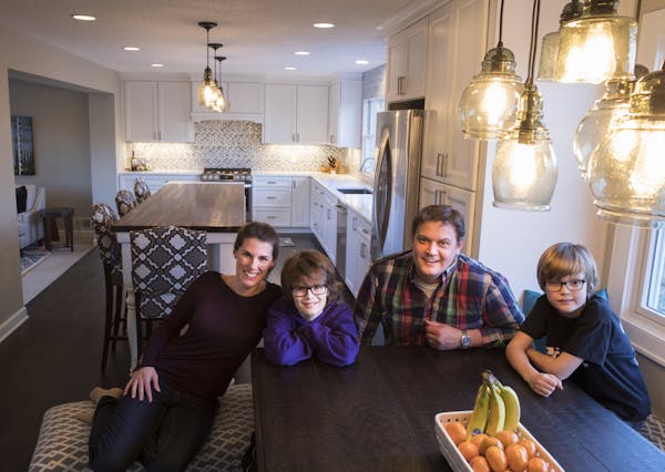 Cassie and Scott Frick and sons, Owen, left, 12, and Cole, 8, enjoy their remodeled and expanded kitchen in Minnetonka.