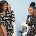FILE - In this Oct. 11, 2016, file photo, first lady Michelle Obama laughs with actress Yara Shahidi while participating in Glamour's "A Brighter Futu