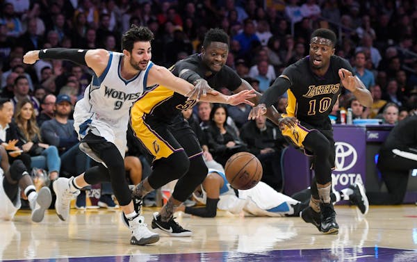 Minnesota Timberwolves guard Ricky Rubio, left, of Spain, scrambles for a loose ball along with Los Angeles Lakers forward Julius Randle, center, and 