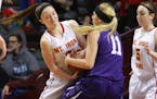 Mountain Iron-Buhl's Macy Savela (3) and Goodhue's Maddy Miller (11) battle for the ball during the first half of the girls' basketball state tourname