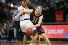 Springfield's Tanner Vogel tried to drive past Minneapolis North's Isaac Johnson during the first half of the boys' basketball Class 1A semifinals at 