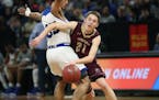 Springfield's Tanner Vogel tried to drive past Minneapolis North's Isaac Johnson during the first half of the boys' basketball Class 1A semifinals at 