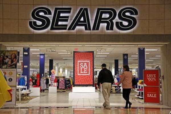 FILE - In this Wednesday, Feb. 8, 2017, file photo, shoppers walk into a Sears store in Pittsburgh. Sears said that there is "substantial doubt" that 