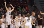 Roseau players begin the celebration near the end their 75-64 victory over Sauk Centre during the girls' basketball state tournament, Class 2A champio