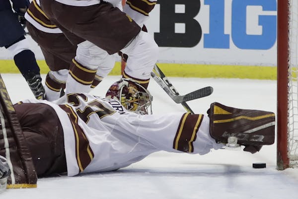 Gophers goalie Eric Schierhorn reached for the puck during the first period against Penn State in the Big Ten tournament. He made 59 saves.