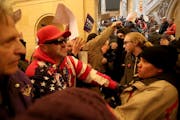 Supporters of President Donald Trump and anti-Trump protesters clashed in the hallway outside the rotunda at a national March4Trump Saturday, March 4,