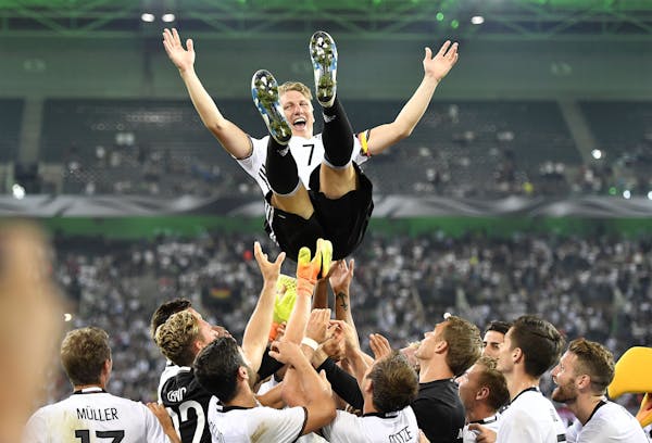 The German national team threw captain Bastian Schweinsteiger into the air after he played his final match for his nation Aug. 31. After more than a d