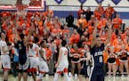 As time expires Champlin Park's Brian Strong (0) signals the win after his team defeated Osseo 79-74 during the Boys' basketball, Class 4A, Section 5 