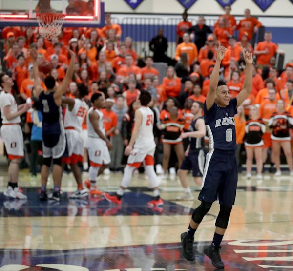 As time expires Champlin Park's Brian Strong (0) signals the win after his team defeated Osseo 79-74 for a trip to state.