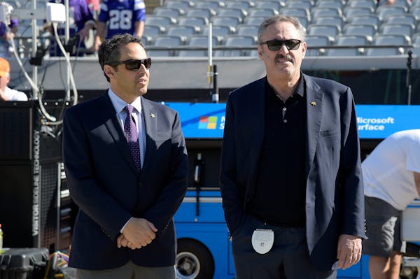 Minnesota Vikings owners Mark Wilf, left, and Zygi Wilf watch warmups on the sideline before an NFL football game against the Jacksonville Jaguars in 