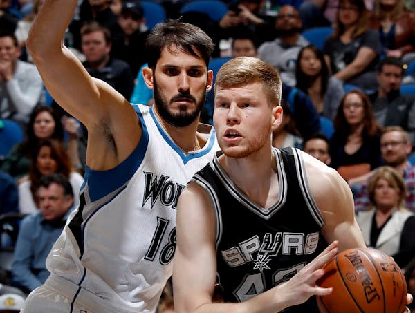 The Wolves' Omri Casspi, left, defending San Antonio's Davis Bertans, is learning new teammates and a new system while also recovering from a broken t