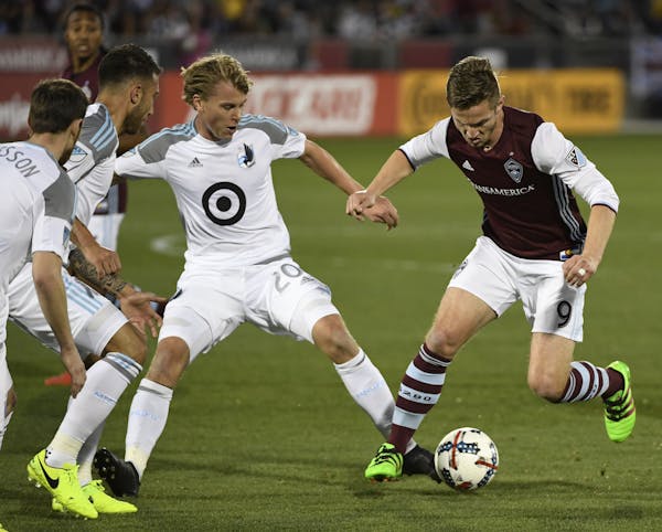 United midfielder Rasmus Schuller (20) made tighter defense a priority against forward Kevin Doyle and the Colorado Rapids.