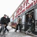 People come to shop in the Surdyk's liquor store in the snow on Sunday, March 12, 2017.
