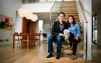 Vincent Jusuf and Catherine Pham relax in their Minneapolis home with their 11-year-old Shih Tzu, Chili.