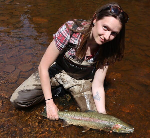 Jade Thomason of Duluth, shown with a North Shore steelhead, is an organizer of this weekend’s Great Waters Fly Fishing Expo presented by Trout Unli