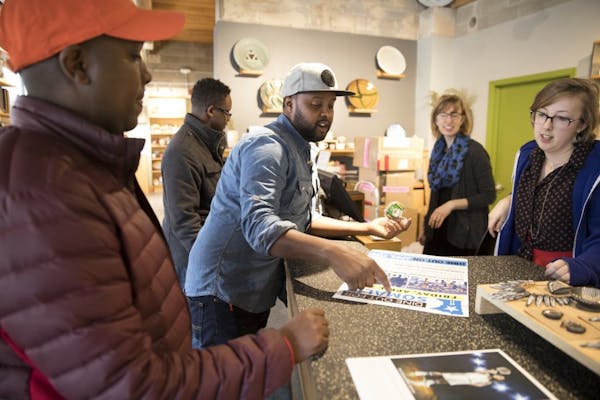 Abdirahman Kahin, from left, owner of Afro Deli, and Burhan Elmi, owner of Capitol Cafe, talked to Alison Beech and Alexa McAdams of the Northern Clay
