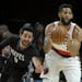 Minnesota Timberwolves guard Ricky Rubio reaches in to try and steal the ball from Portland Trail Blazers guard Allen Crabbe during the first half of 