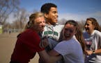 Charlie Etuko was greeted with hugs from Erin Saemrow, Briana Cline and Lucia Ranallo (Jeff Wheeler, Star tribune)