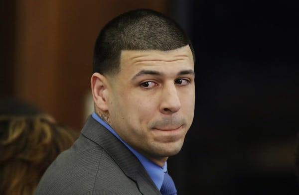 Former New England Patriots tight end Aaron Hernandez turns to look in the direction of the jury Friday as he reacts to his double murder acquittal at