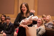 Sen. Melisa Franzen, DFL-Edina, holds her six-day-old son during the first session of Minnesota Senate chambers.