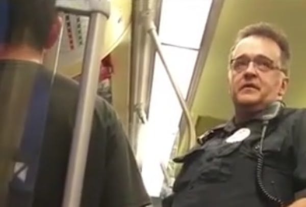 In this photo taken from video, a Metro Transit police officer asked a Blue Line light-rail passenger for his immigration status, leading another pass