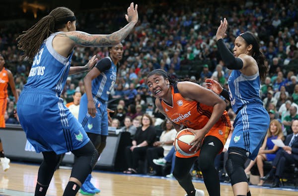 Connecticut Sun forward Morgan Tuck (33) looked for the basket over Minnesota Lynx guard Seimone Augustus (33) and Maya Moore