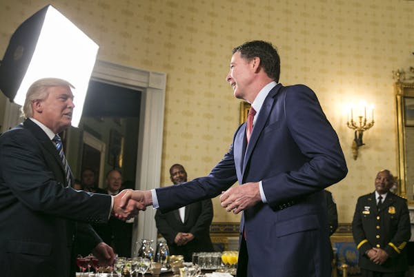 James Comey, the director of the FBI, shakes hands with President Donald Trump at a reception for law enforcement officers and first responders who he