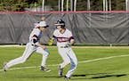 Stillwater's Matt McGinley, left, chased down teammate Drew Gilbert in celebration of Gilbert's double in the bottom of the eighth inning that lifted 