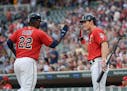 Minnesota Twins third baseman Miguel Sano (22) and center fielder Max Kepler (26) high fived after Sano scored a run off a single by right fielder Rob