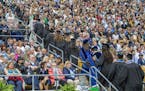 Notre Dame graduates walk out of Notre Dame Stadium in protest as Vice President Mike Pence speaks during the 2017 commencement ceremony, Sunday, May 