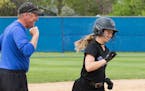 Woodbury third base coach Bob Nickleby and senior Shannon Motzko are all smiles after Motzko's second inning homer against Stillwater. The Royals defe