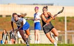 Farmington's Ashley Steffes drove against Eastview's Mary Keating during the Tigers' 14-10 victory. Steffes' five first-half goals got the Tigers roll