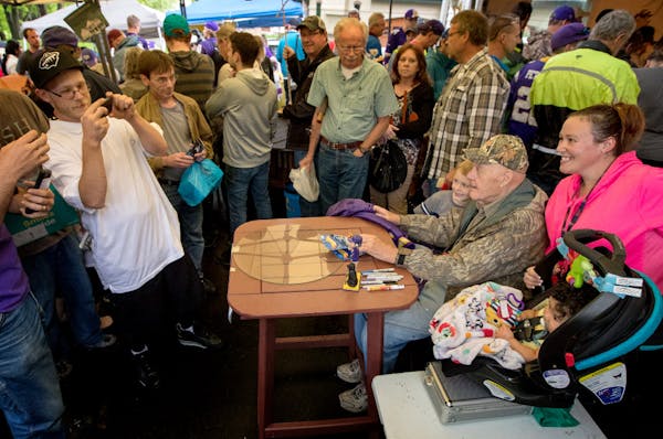 Bud Grant posed for a photo with people attending his garage sale.