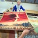 Mona Weselmann a Collections Specialist at the Flaten Art Museum at St. Olaf College, laid out WWII Nazi propaganda posters collected by historian Dun