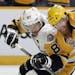 Penguins captain Sidney Crosby, left, battled Nashville defenseman Ryan Ellis for position during Game 3 on Saturday night.