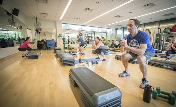 Employees at Allianz Life exercised during a class at their on-site fitness center. Allianz’ True Balance wellness program also helps employees with