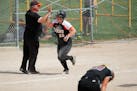 Farmington infielder Emma Frost high fived coach Paul Harrington after her game-winning home run at the bottom of the tenth inning. ] MARK VANCLEAVE �
