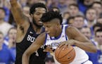 Creighton's Justin Patton, right, is defended by Butler's Tyler Wideman (4) during the first half of an NCAA college basketball game in Omaha, Neb., W