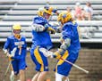 Wayzata’s Riley Nelson, left, congratulates teammate Christopher Thiry after his first-half goal in the Trojans’ 6-5 quarterfinal victory over Ede