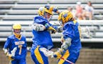 Wayzata’s Riley Nelson, left, congratulates teammate Christopher Thiry after his first-half goal in the Trojans’ 6-5 quarterfinal victory over Ede