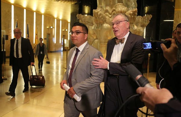 Jeronimo Yanez, middle, with his attorney Tom Kelly, right, and other legal team members while leaving the Ramsey County Courthouse on May 30 in St. P