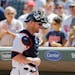 Fans applaud for Minnesota Twins catcher Chris Gimenez as he heads for the dugout after the Twins beat the Seattle Mariners 6-2 in a baseball game Thu