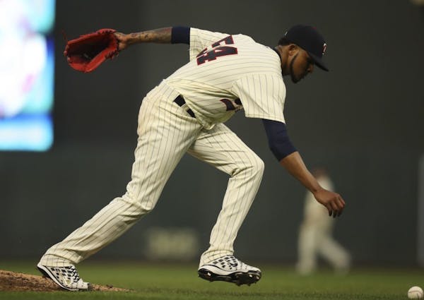 Minnesota Twins starting pitcher Ervin Santana reached for the ball after knocking down a line drive by Los Angeles Angels first baseman Luis Valbuena