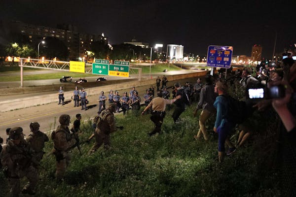 Police round up demonstrators at I94 and Dale St. early Saturday morning, making several arrests. Earlier, supporters of Philando Castile held signs a
