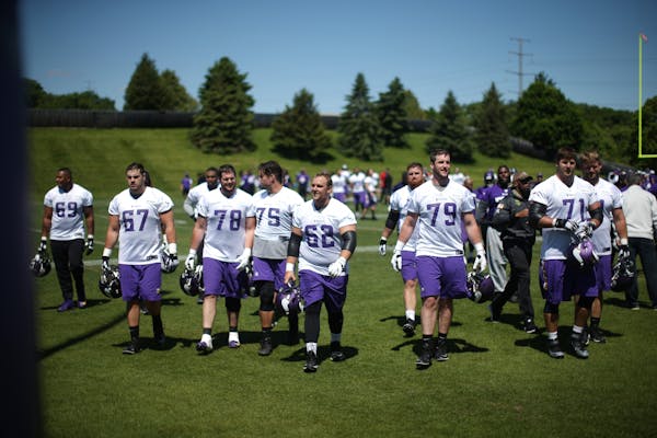 Members of the Vikings offensive line walked of the field after practice Wednesday May 31,2017 in Eden Prairie, MN.