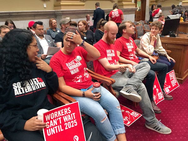 Supporters of raising the city minimum wage to $15 an hour fill the Minneapolis City Council chambers before the start of a council committee hearing 