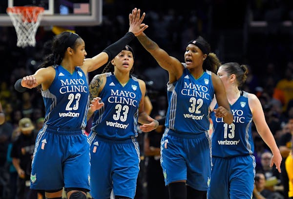 Members of the Minnesota Lynx, from left, Maya Moore, Seimone Augustus, Rebekkah Brunson and Lindsay Whalen celebrate during the second half in Game 4