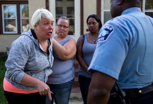 Jennifer LeMay, left, explained to Lieutenant Derrick Barnes what happened when an officer shot her dogs at her Minneapolis home.